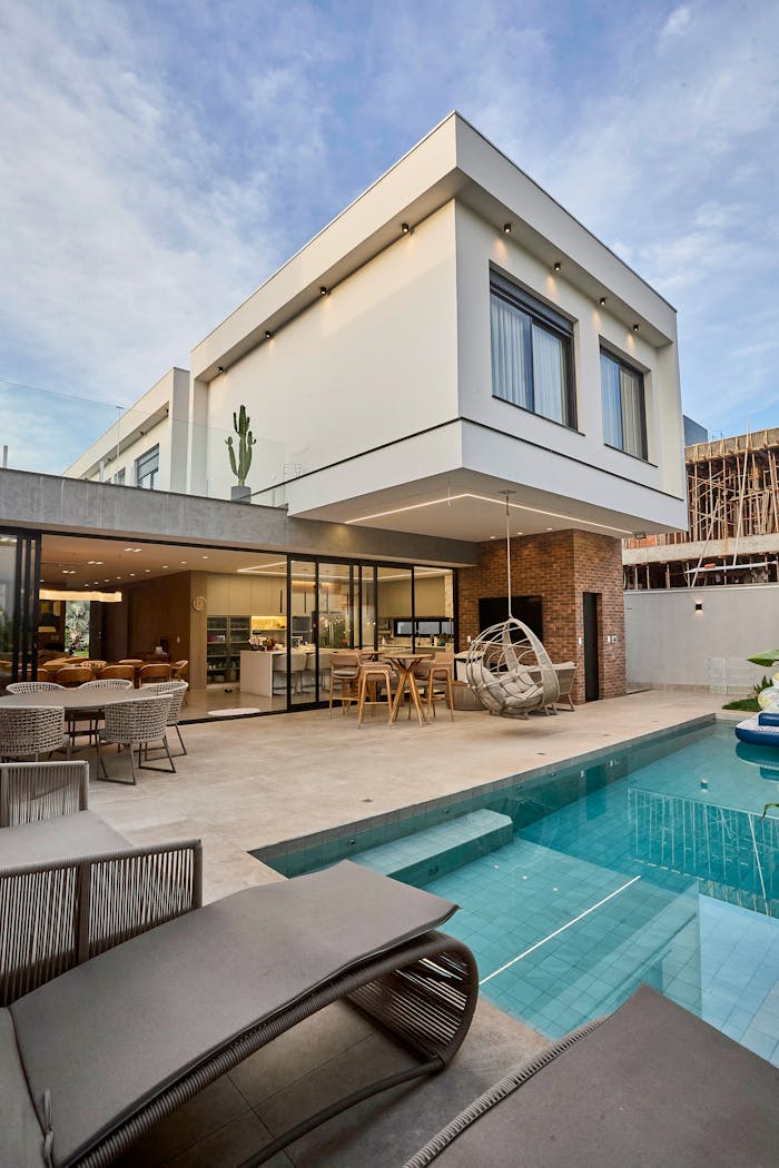Explore this stunning modern home featuring an elegant poolside area.